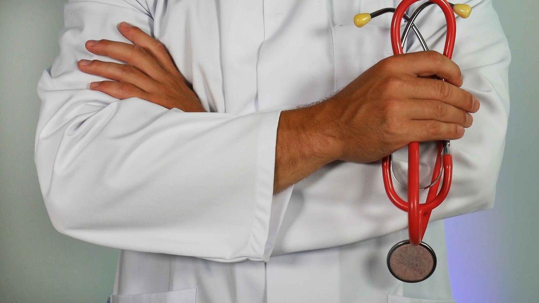 Doctor holding red stethescope