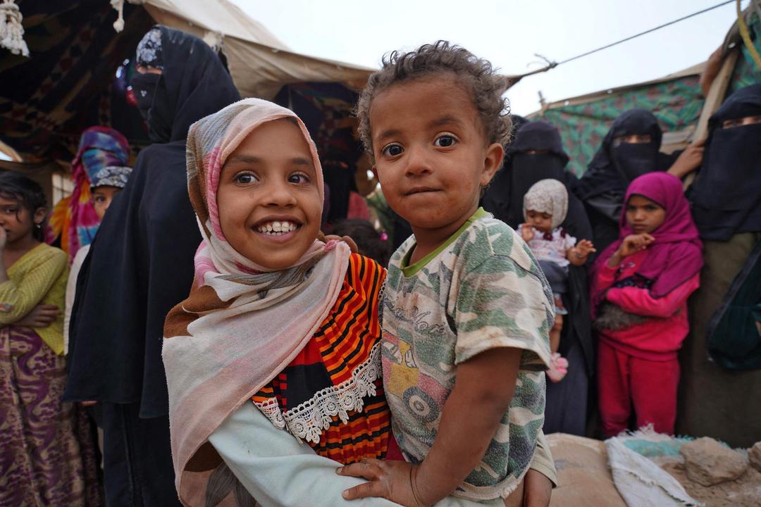 girl holding child