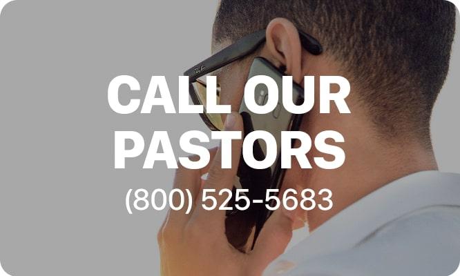a person on a cell phone with the text 'call our pastors 800-525-5683' at center
