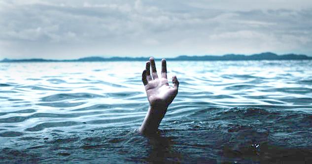 Hand reaching for help, drowning in ocean