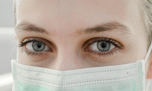 Close up of nurse, kind eyes, wearing mask